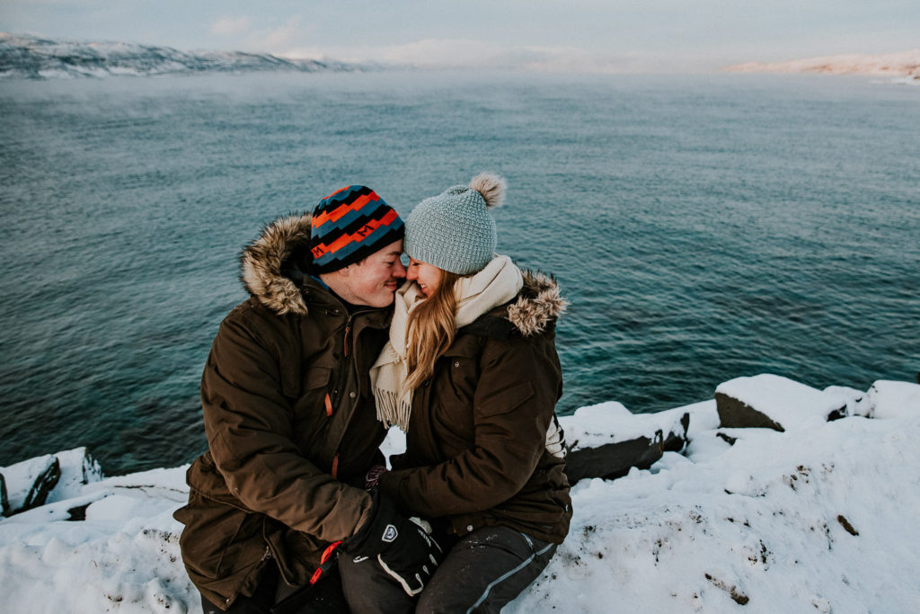 Beautiful couple getting engaged by norwegian fjords Northern Norway