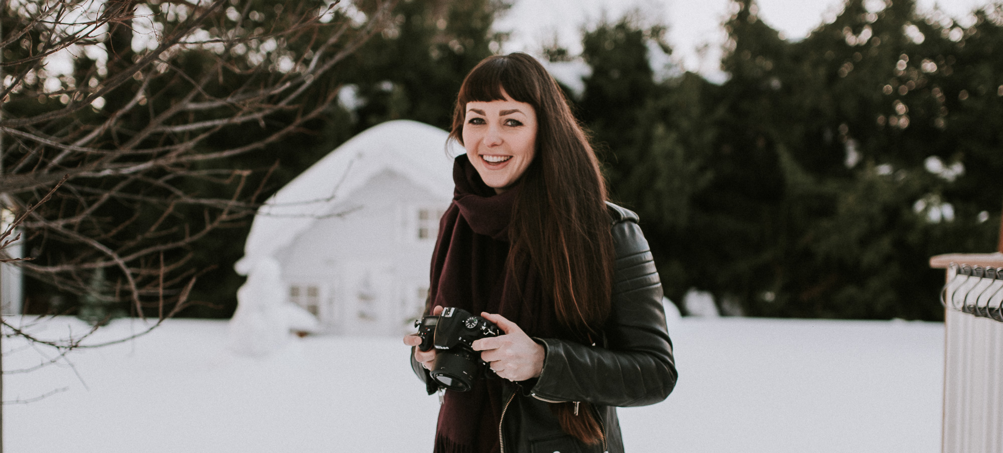 SMiling photographer in front of winter landscape