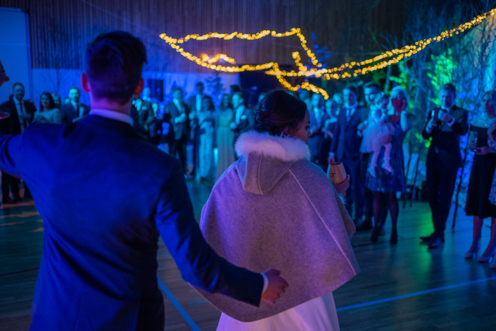 Bride and groom entering stunning reception hall