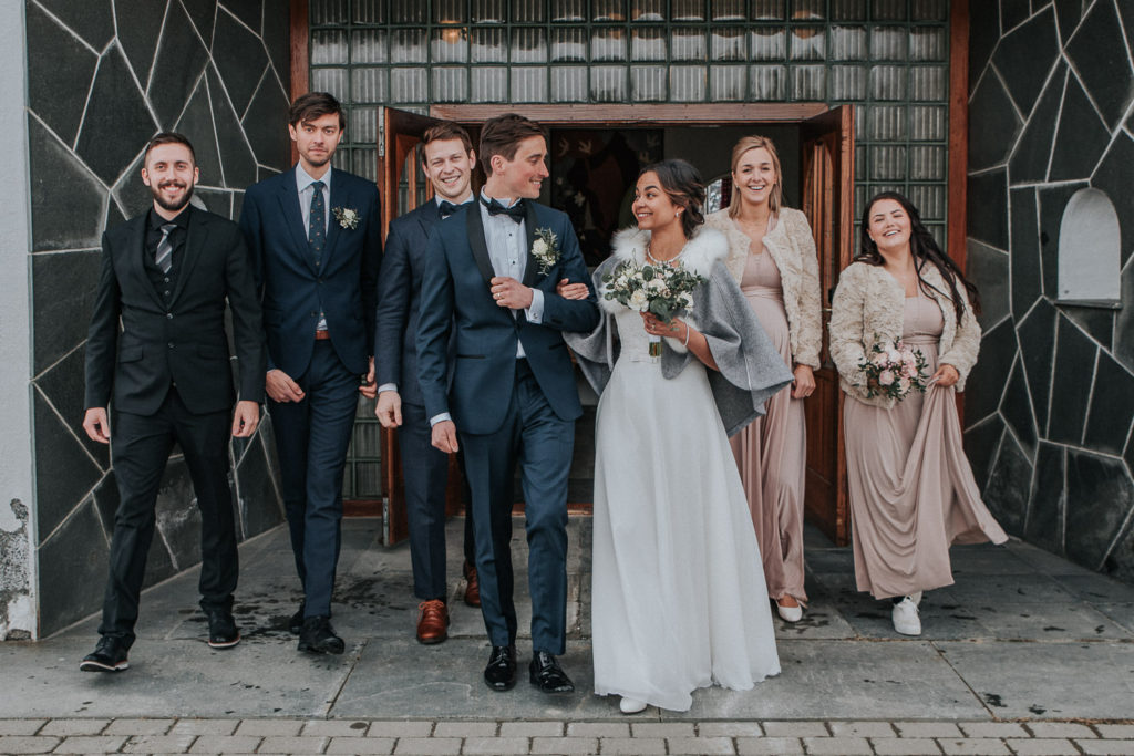 Group portrait with bridesmaids in front of church