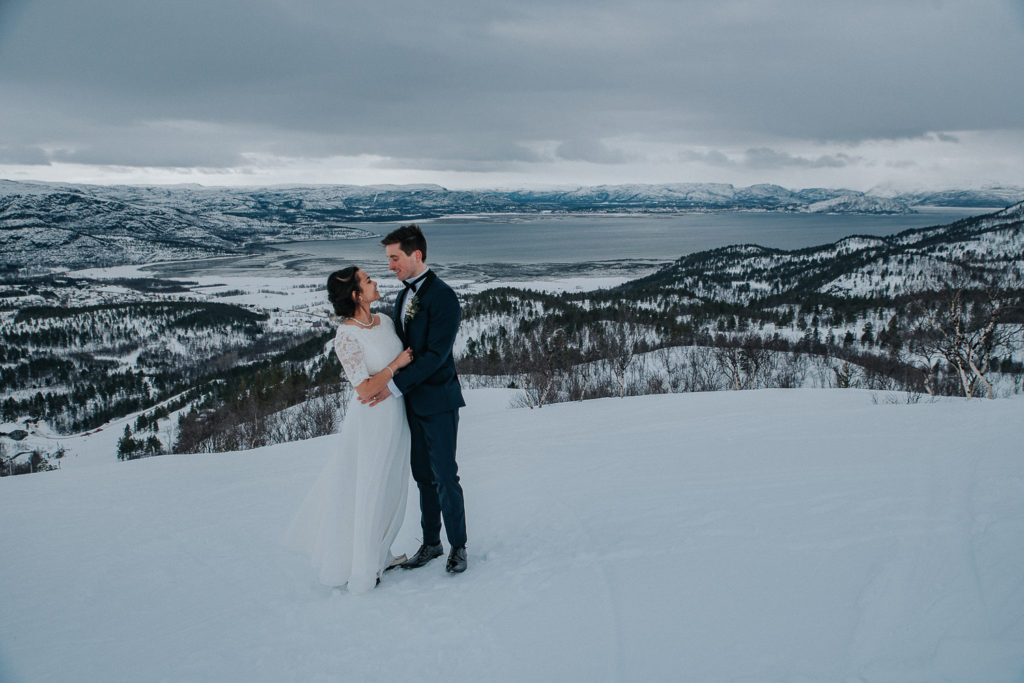 Beautiful bride and groom in front of amazing winter landscape