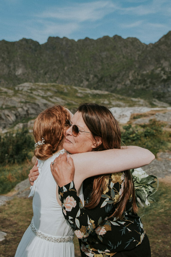 Weddinh planner gives a hug to the bride after the elopement ceremony in Lofoten Norway