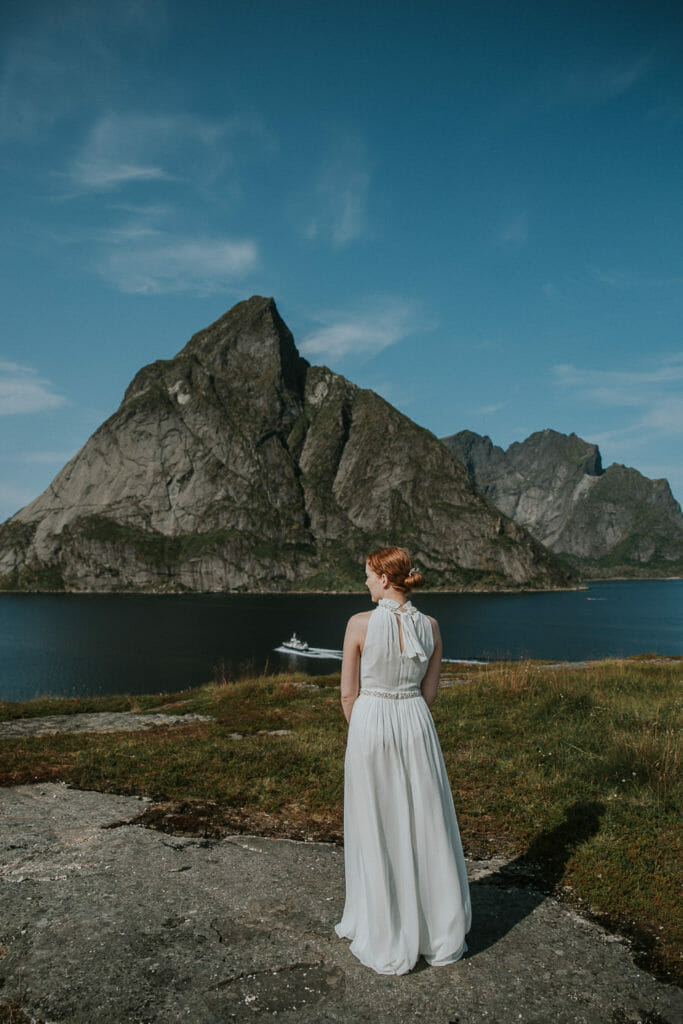 Beautiful bride with a wedding bouquet in white tones in front of mountains landscape in Lofoten Norway