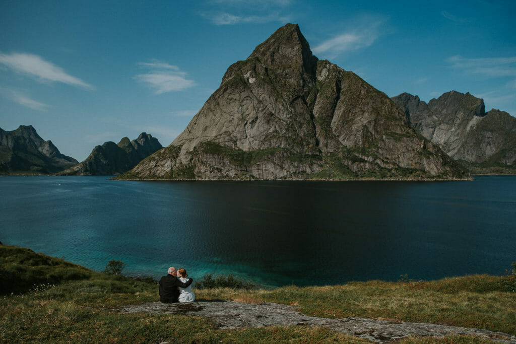Bride and groom kissing each other in front of stunning views of Lofoten islands
