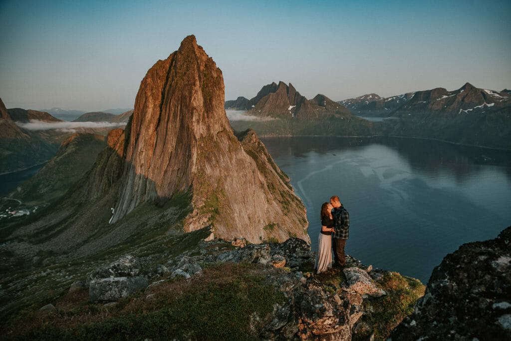 Couple kissing in front of amazing mountain Segla in Senja in the sunset - best places to elope in Northern Norway Troms county