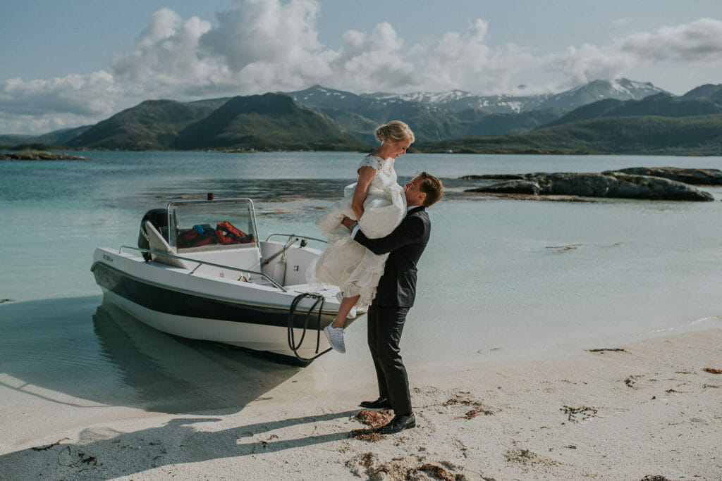 Senja wedding photographer captured beautiful moment when the groom lifts his beautiful bride and swirl her around in front of the amazing landscapes of Senja
