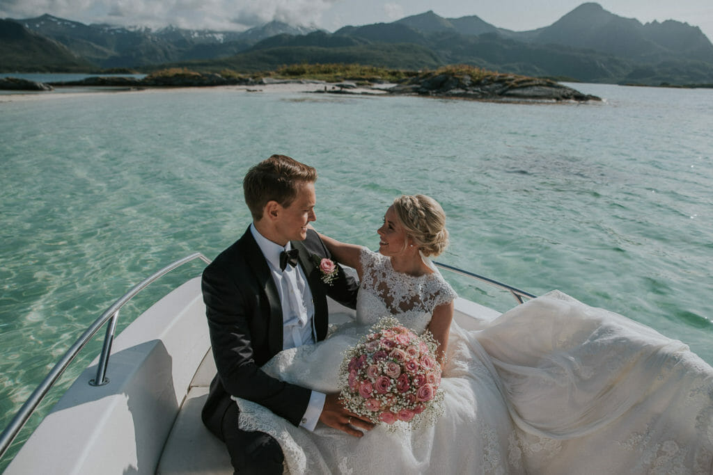 Gorgeous bride and groom sitting on the boat having a good time