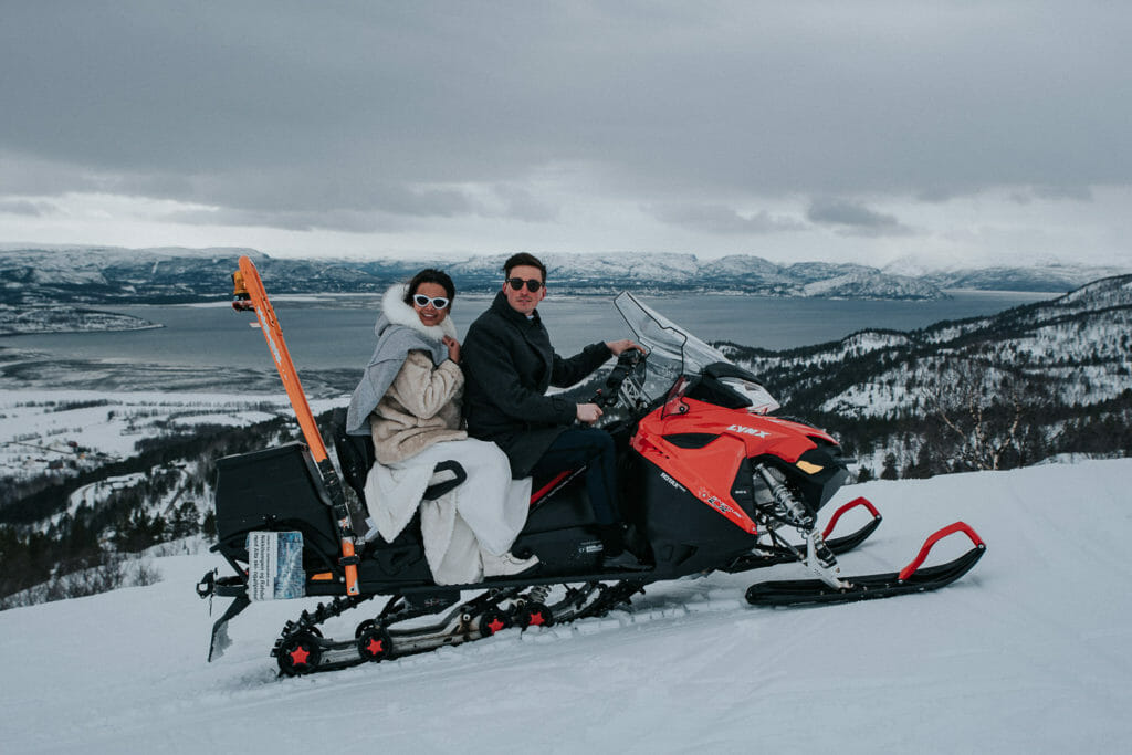 Snowmobile wedding in Alta Norway - bride and groom arrived to the mountaintop on snowmobile