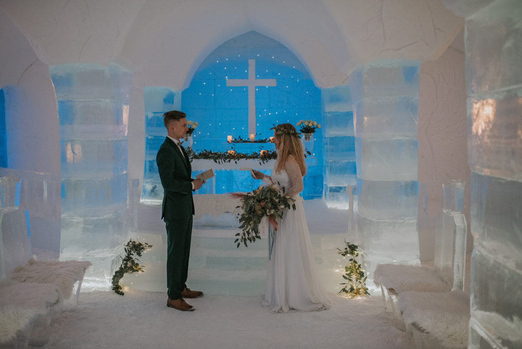 Bride and groom reading vows in the ice chapel of Igloo hotel Sorrisniva Alta 