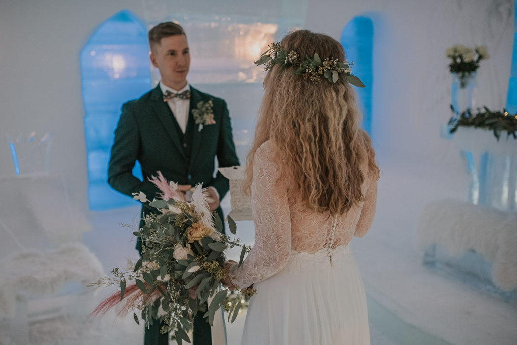 Bride reads her vow to the groom on the wedding day in ice hotel in Alta, Norway