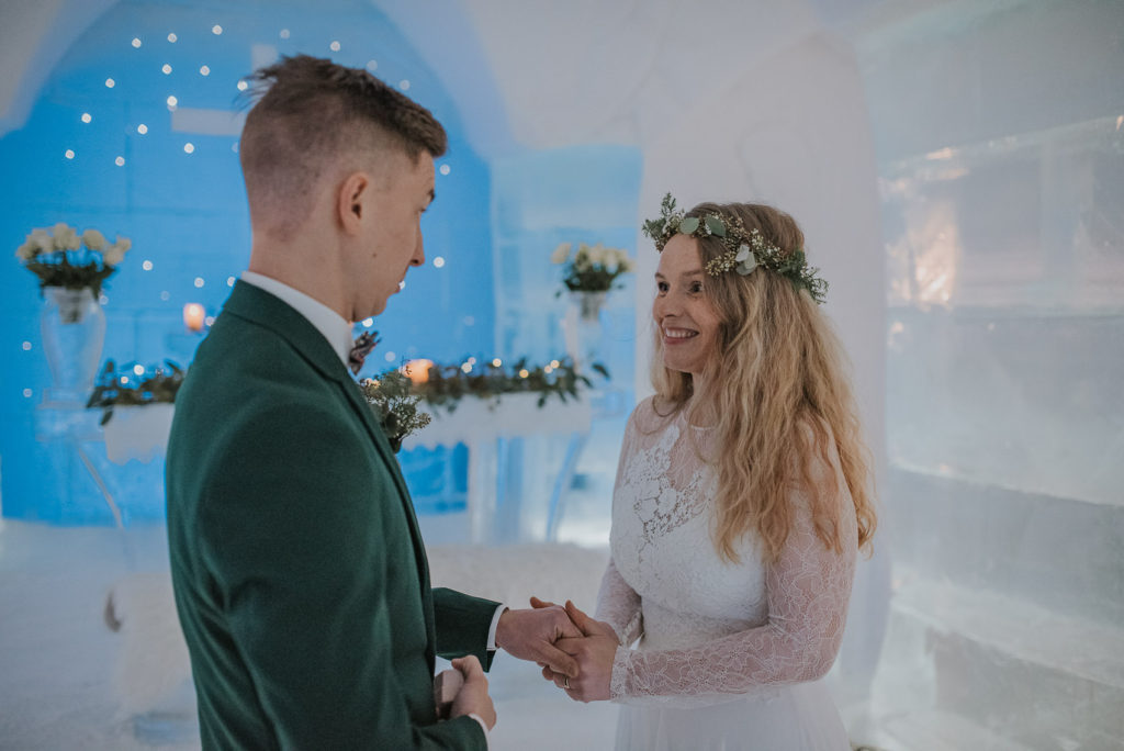 Bride and groom exchanging the rings on their wedding day - while Norway wedding photographer is capturing lovely moments
