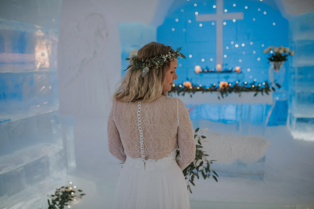 Gorgeous details of a lace-back wedding dress  with the stunning views of ice hotel in Alta Norway
