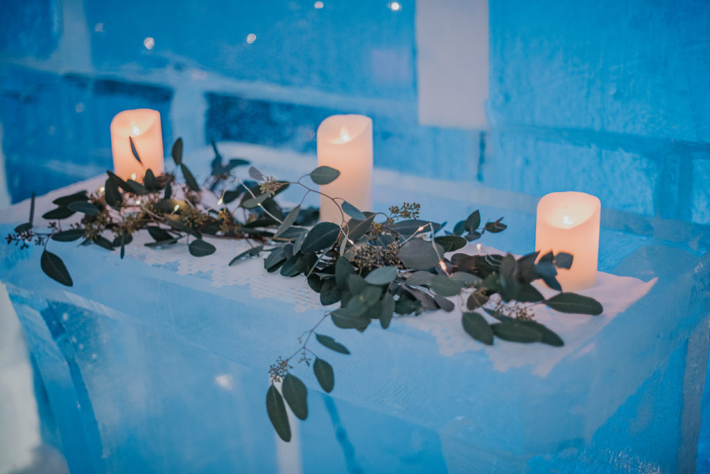 Ice chapel Sorrisniva Alta decorated with fresh flowers and green eucalyptus with candles