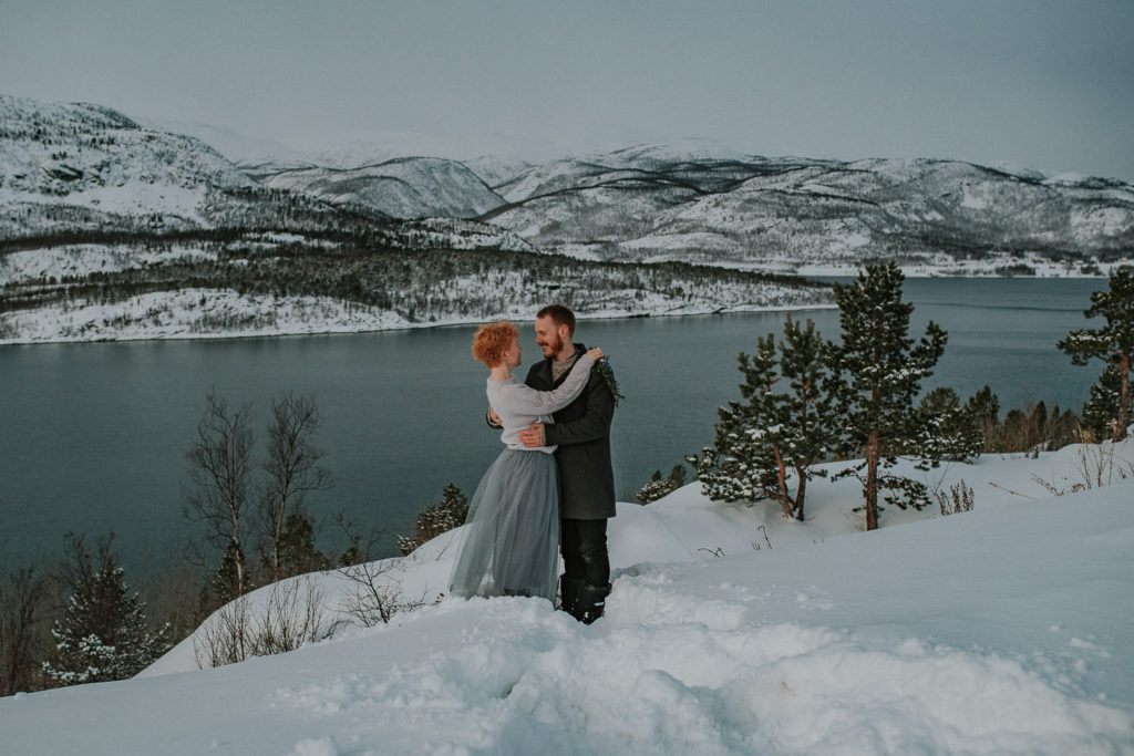 Planning guide for adventure elopement in Norway - Norway elopement photographer captured beautiful couple among winter surroundings in Alta Norway