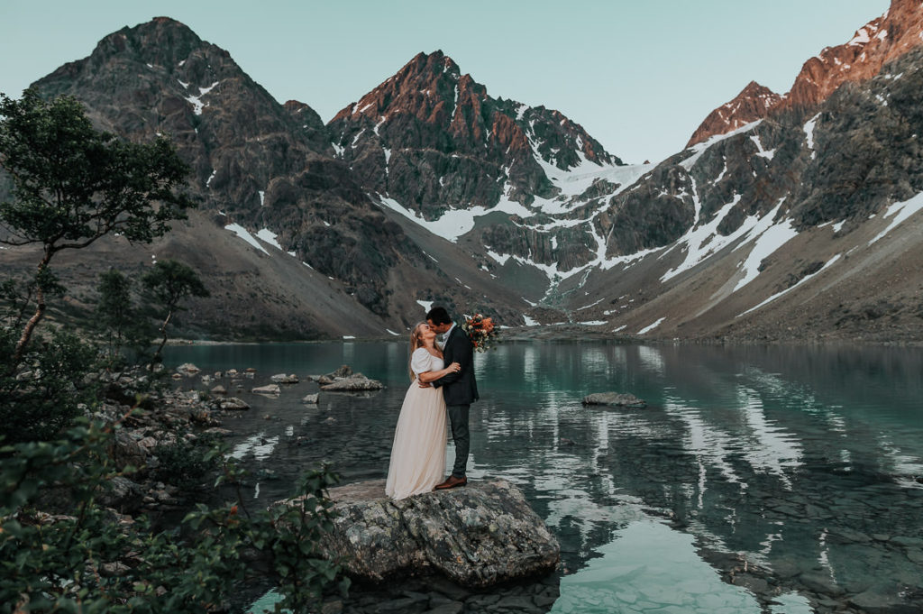 First look for bride and groom in front of stunning mountains and claciers in Lyngen Alps Troms Norway - best elopement locations
