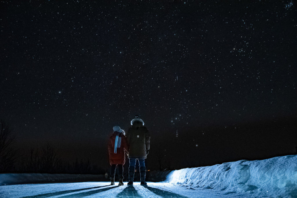 Beautiful couple gazing at the stars and waiting for Northern lights in Alta Northern Norway 