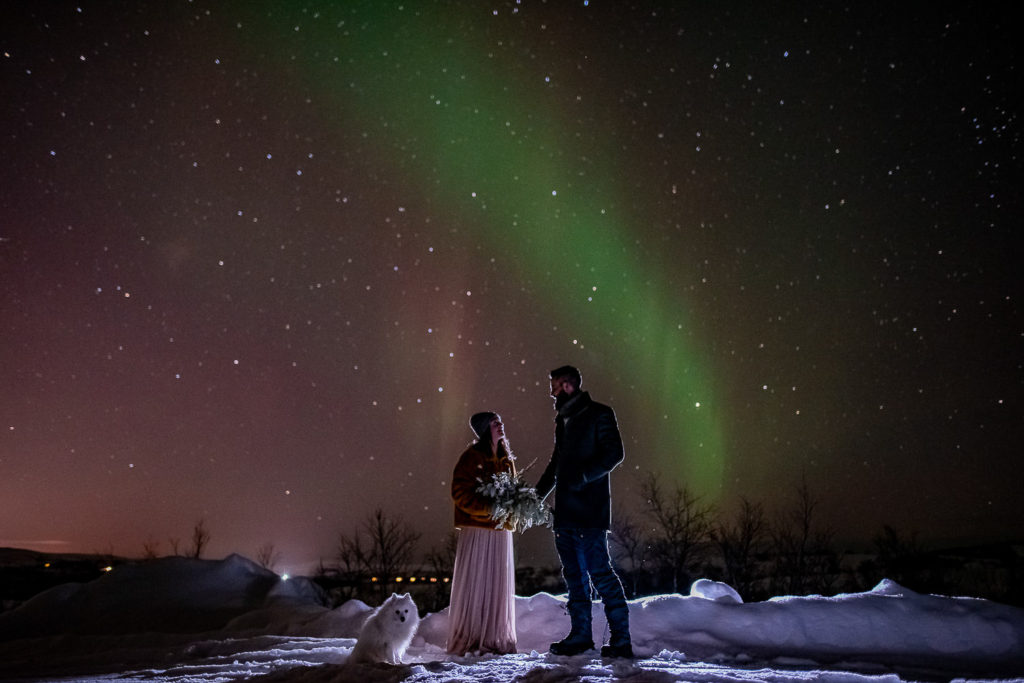 Stunning portraits of bride and groom under Aurora Borealis in Norway