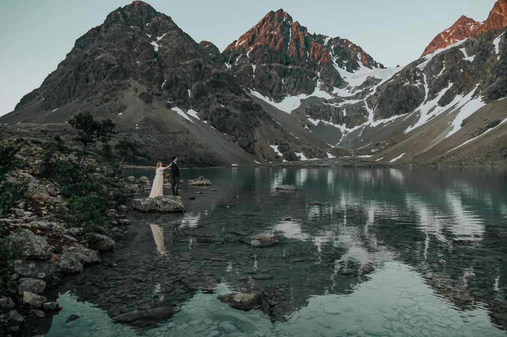 First look by the alpine lake on elopement day in norwegian mountains 