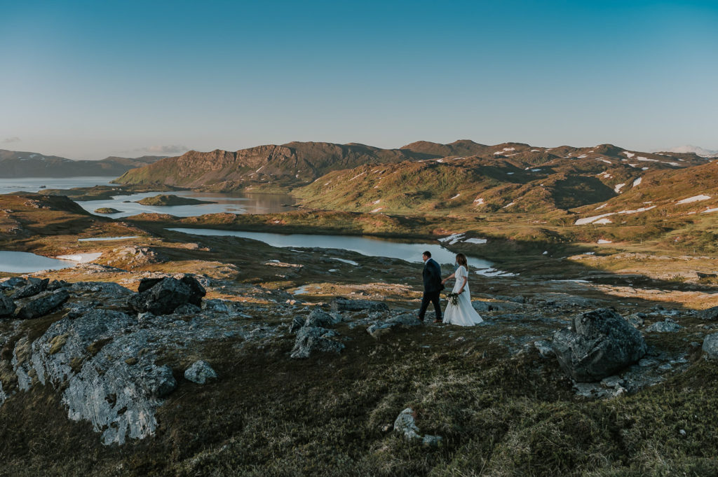 Bride and groom walking in the mountains in Norway on their adventure elopement day