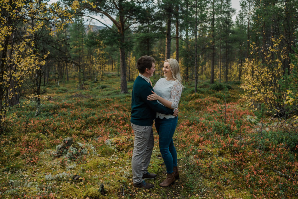 Fall engagement photo session among beautiful colors in the woods 