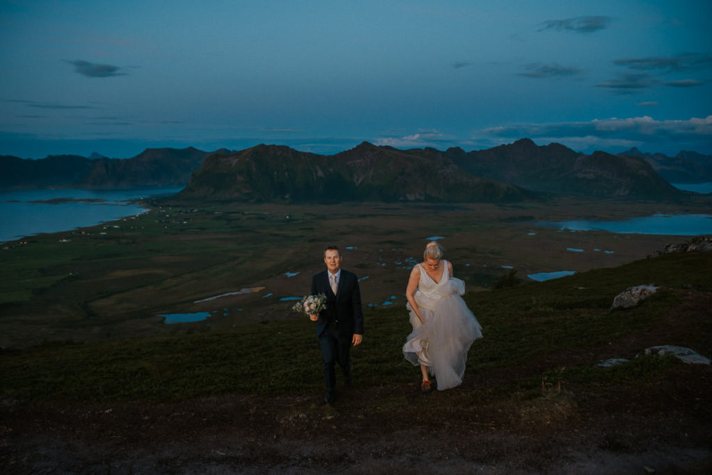 Bridal couple wandering in the mountains of Lofoten