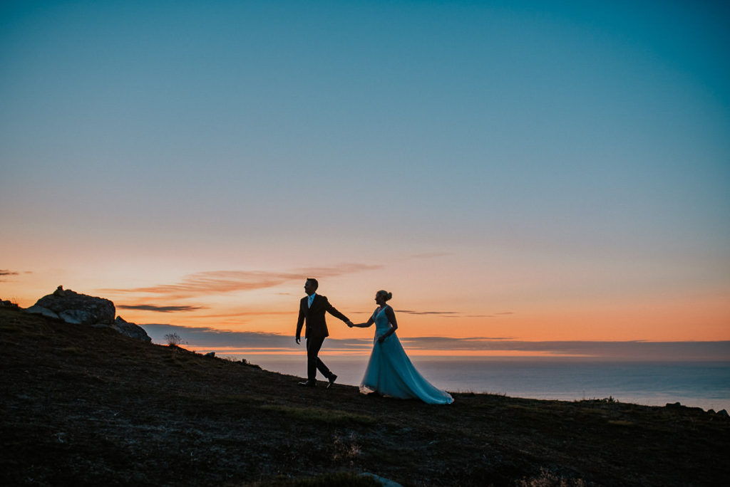 Amazing sunset portrait of the bride and groom in Lofoten islands on the day of their adventure elopement