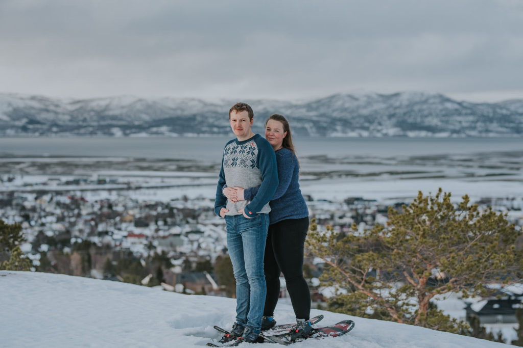 Snowshoeing engagement photo session in Alta, Norway - beautiful couple portrait on a mountaintop with snowshoes