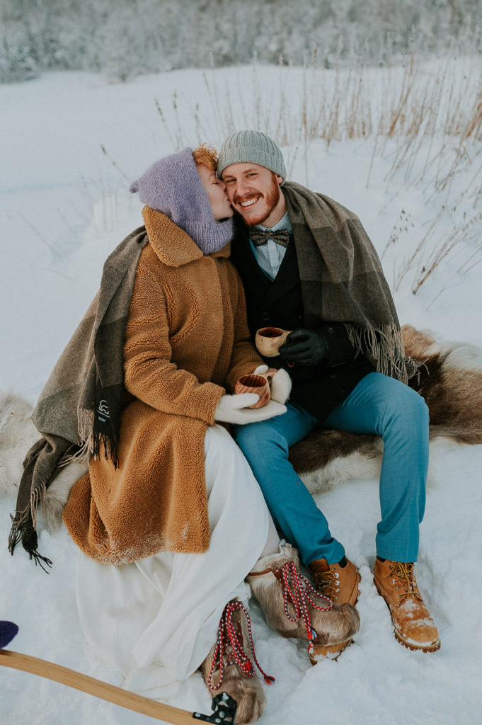 Bride and groom having coffee break on the day of their winter elopement in Norway