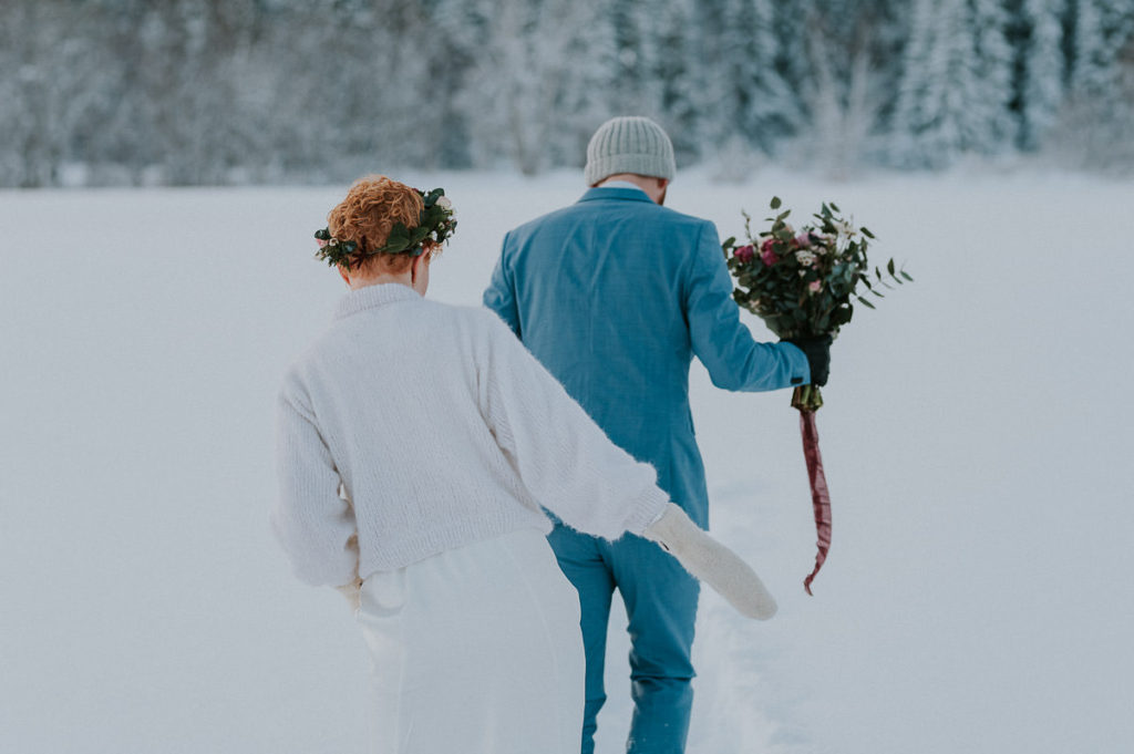 Bride and groom walking to their winter elopement location