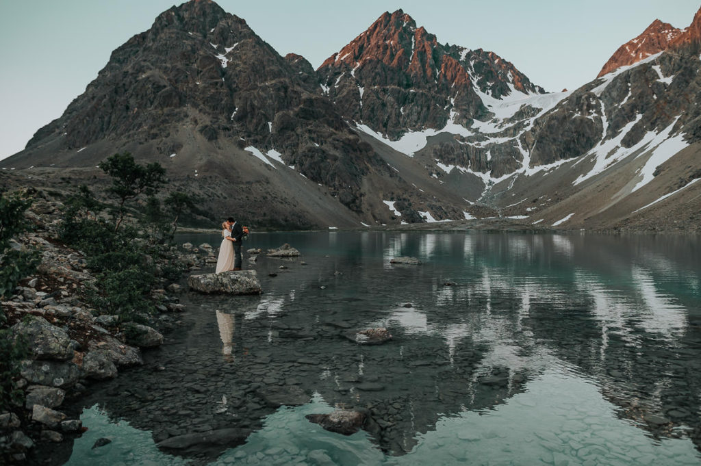 Bride and groom kissing on their pre-wedding ceremony in Lyngen Alps in Norway