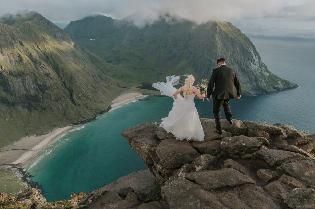 Adventure mountain wedding in Lofoten - bridal portraits at a mountaintop with a stunning view