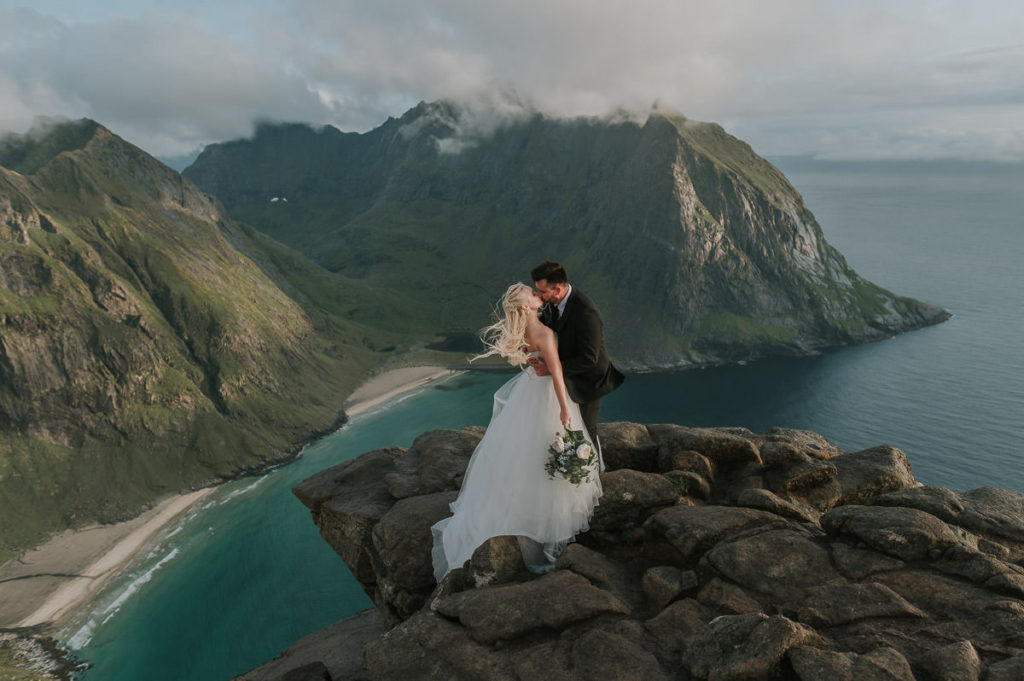 Adventure mountain wedding in Lofoten - bridal portraits at a mountaintop Ryten with a stunning view