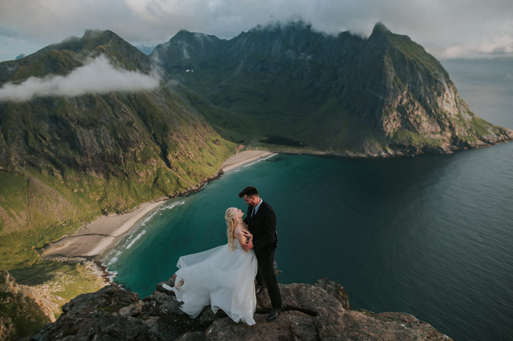 Adventure mountain elopement  wedding in Lofoten - bridal portraits at a mountaintop Ryten with a stunning view