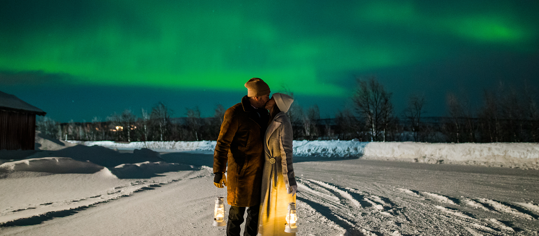 Bride and groom kissing under the northern lights on the day of their elopement in Alta Norway