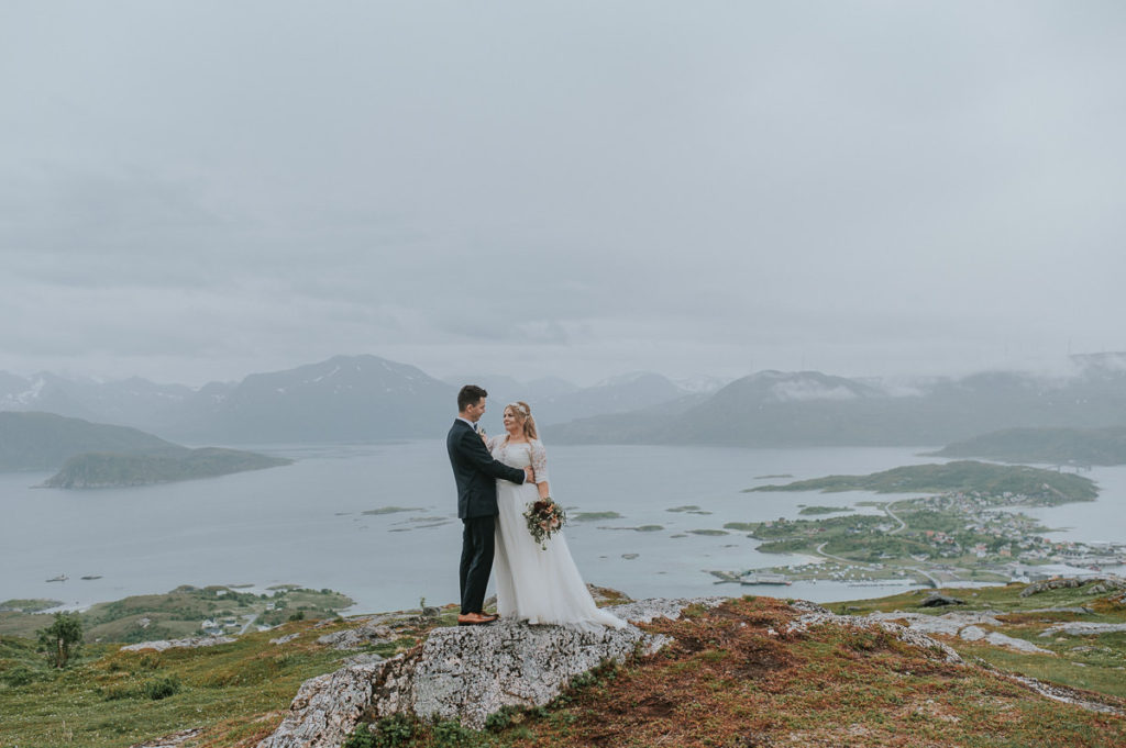 Bridal portrait on a mountaintop overlooking Sommarøy and Tromsø - by wedding photographer in Tromsø Norway