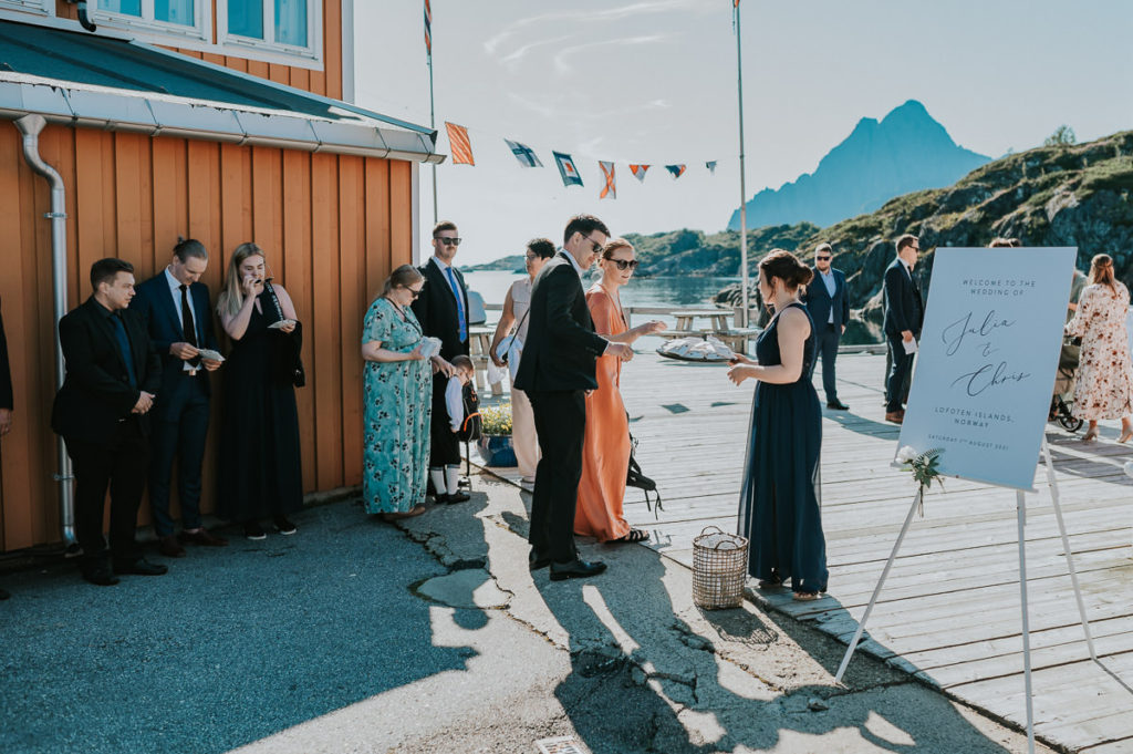 Outdoor summer wedding ceremony at Nyvågar rorbu hotel in Kabelvåg Lofoten