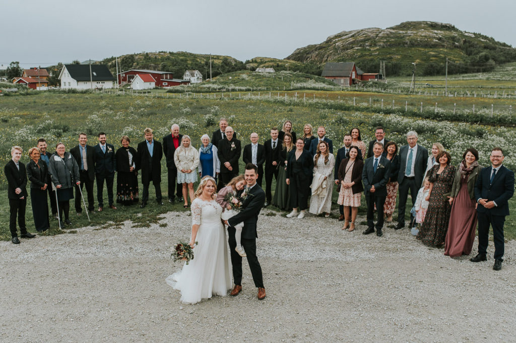 Family and group photo with the bride and groom outside Hillesøy church in Tromsø 