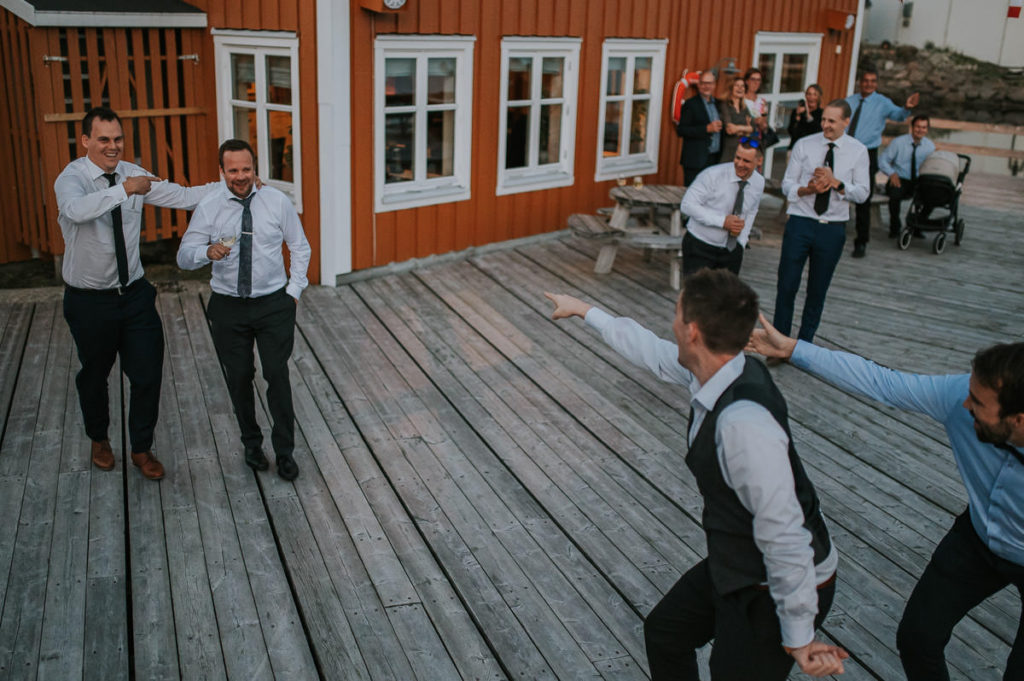 wedding party in Nyvågar rorbu hotell in Kabelvåg Lofoten. Guests are having good time and laughing all the time