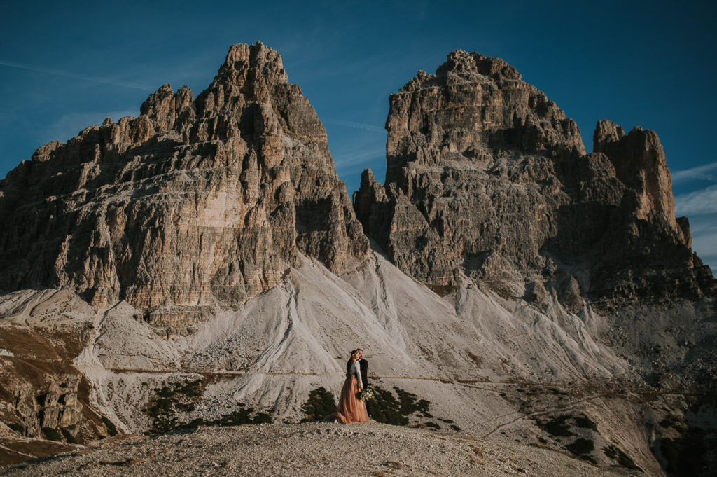 Bride and groom portrait in front of an epic mountain in Italian Dolomites 