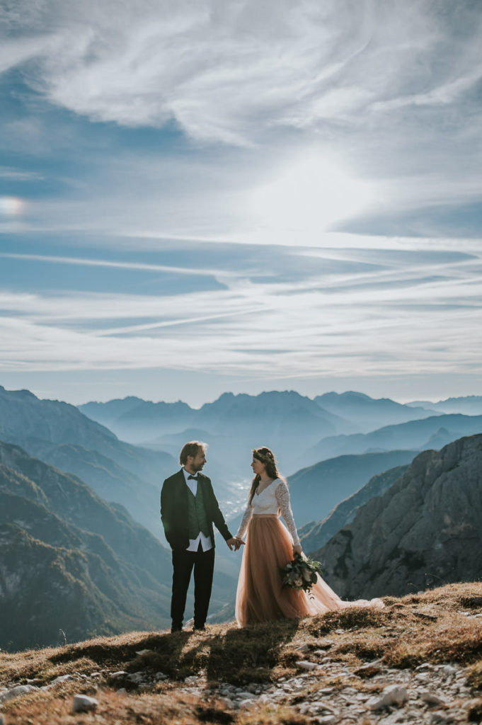 Bridal couple in front of a beautiful mountain landscape in Italian Alps