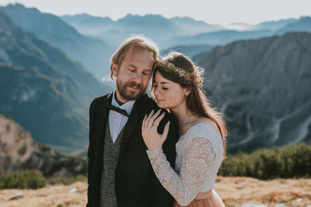 Bridal couple in front of a beautiful mountain landscape in Italian Alps