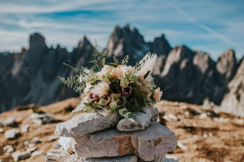 Bridal bouquet in front of stunning Italian Dolomites - captured by Dolomites wedding photographer TS Foto Design