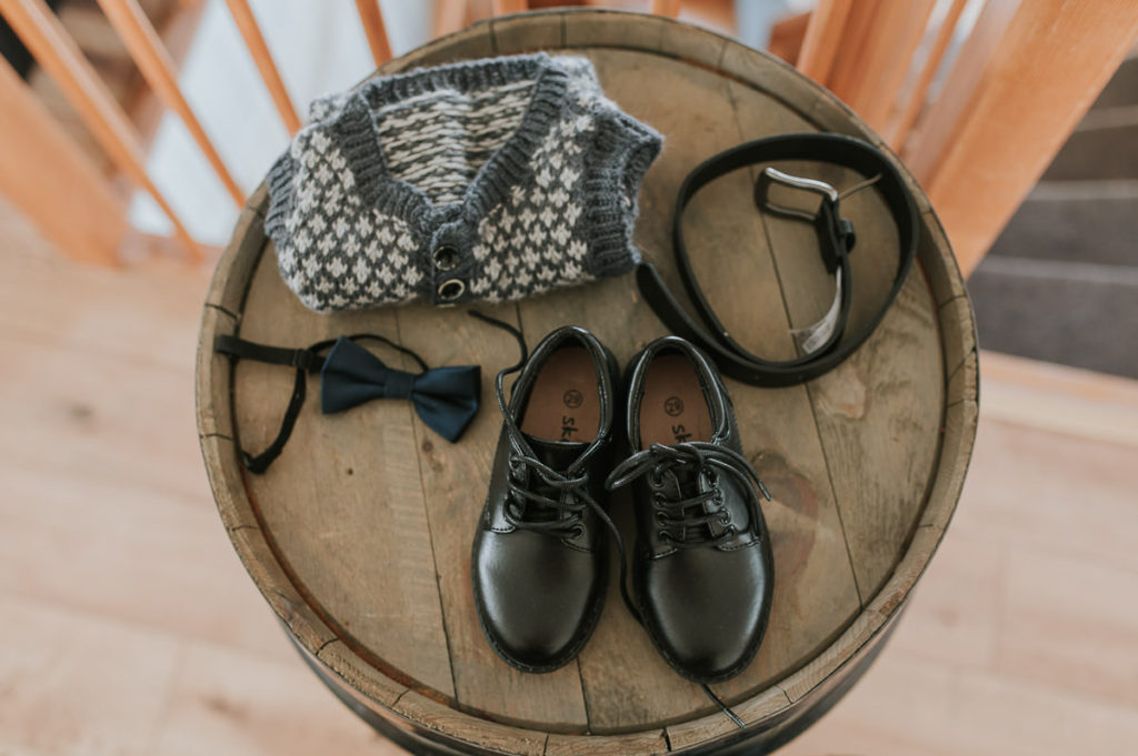 Wedding details with a boy shoes and clothes