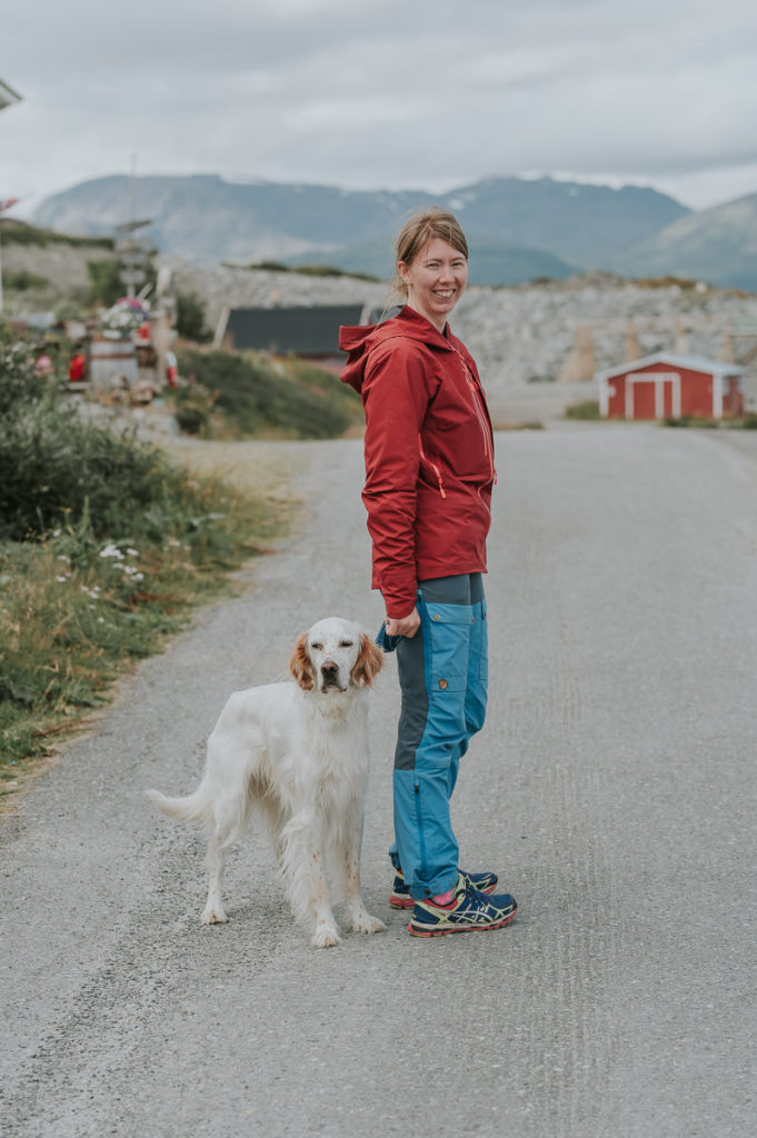 A bride in a hiking clothes walking her dog before getting ready to her wedding day in Norway