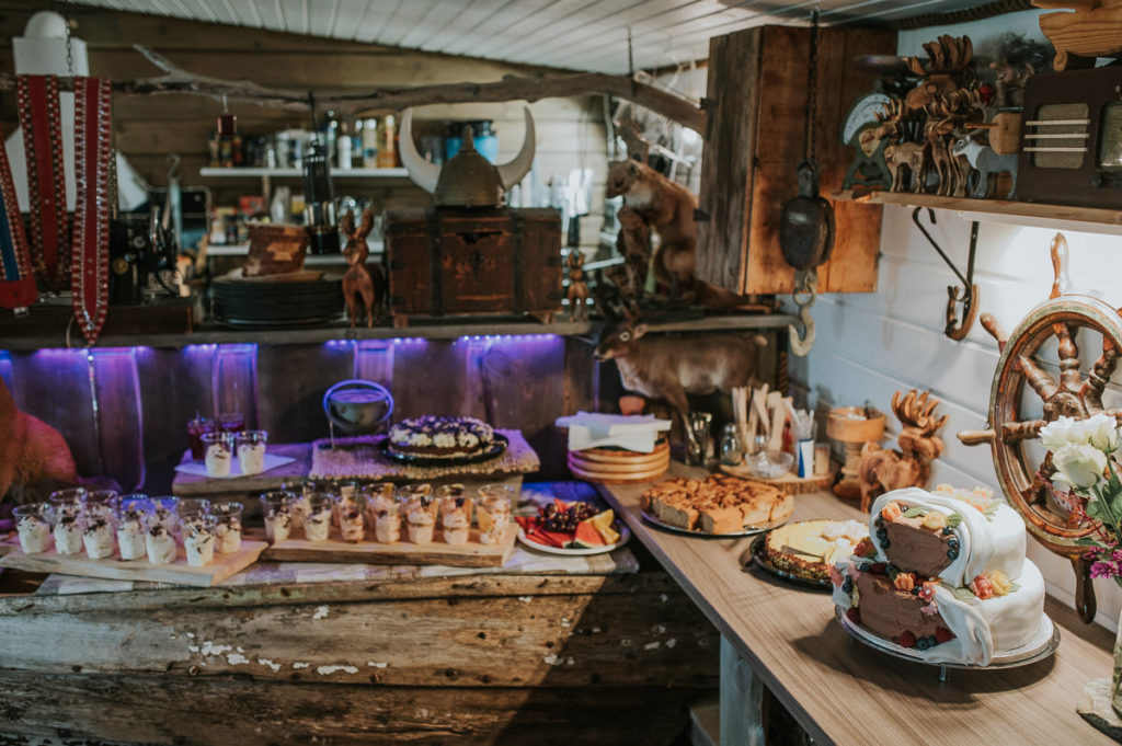 Cake and dessert table in a rustic styled wedding reception location in Storekorsnes Alta Norway