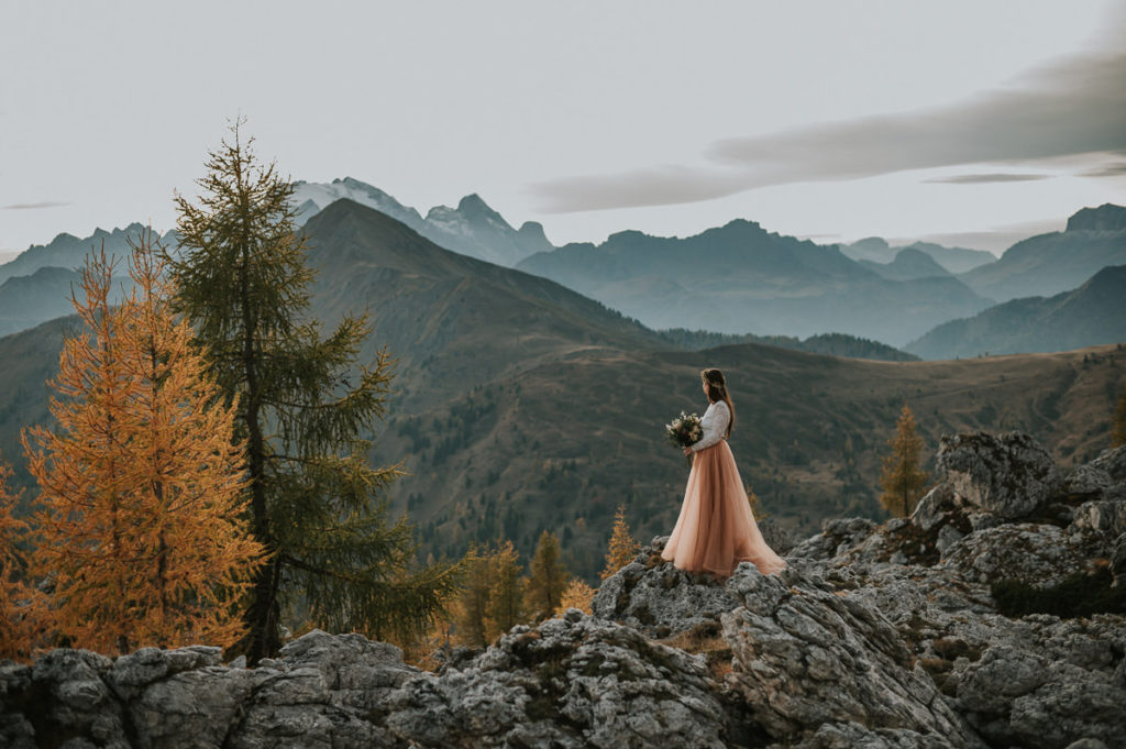 Beautiful bride with a stunning mountain view of Italian Alps - captured by Dolomites wedding photographer