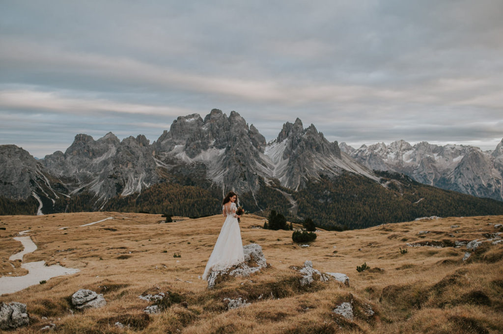Stunning bride posing in front of Italian Dolomites 