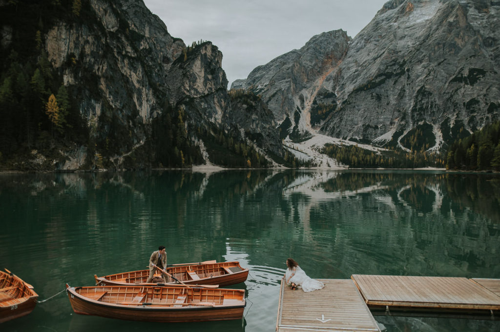 Bride and groom getting ready for a boat tour on the day of their elopement on Lago di Braies in Italy