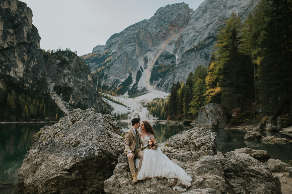 Bride and groom hugging after their elopement ceremony at Lago di Braies in Dolomites