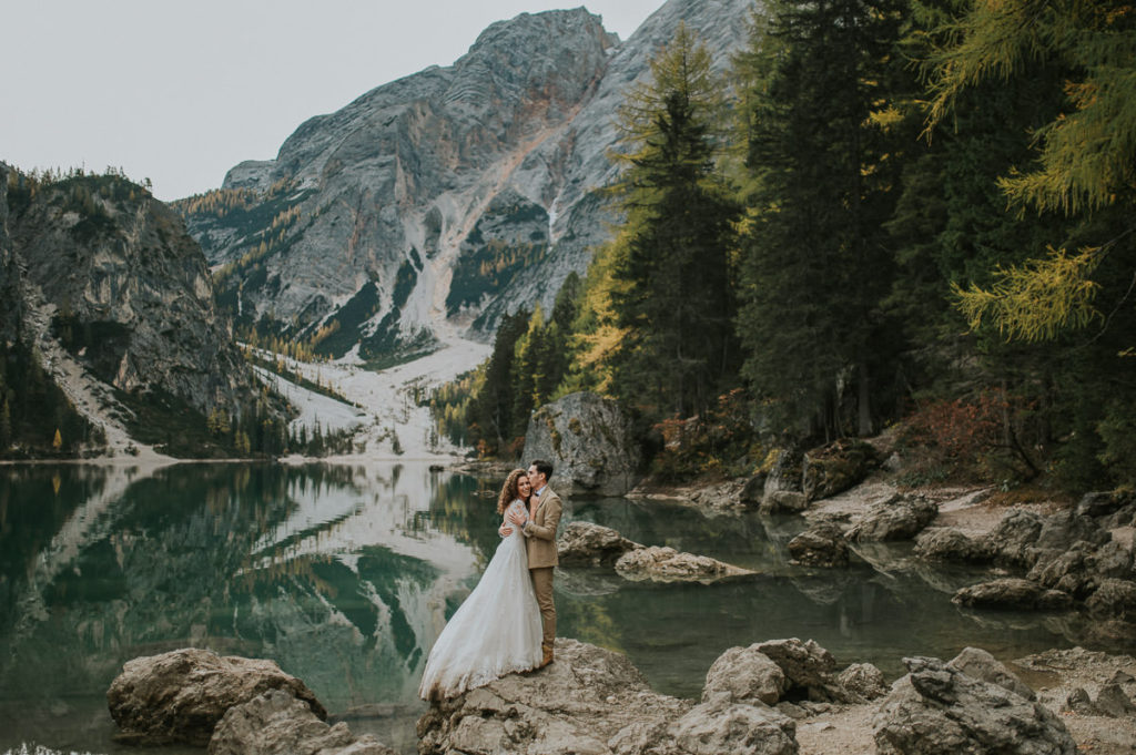 Bride and groom hugging after their elopement ceremony at Lago di Braies in Northern Italy